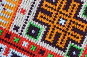 Traditional Ukrainian folk art knitted embroidery pattern on textile fabric photo