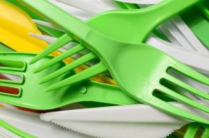 Pile of bright yellow, green and white used plastic kitchenware appliances photo