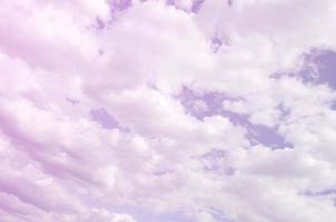 A blue sky with lots of white clouds of different sizes photo