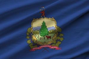 Vermont US state flag with big folds waving close up under the studio light indoors. The official symbols and colors in banner photo