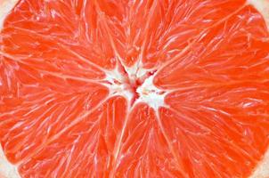 Top view of a fragment of the grapefruit slice close up. Macro background texture photo