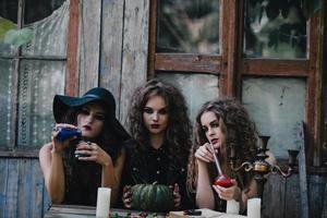 Three vintage witches perform magic ritual photo