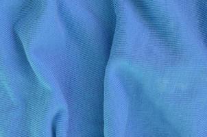 The texture of the fabric in blue color. Material for making shirts and blouses photo