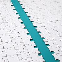 The blue path is laid on the platform of a white folded jigsaw puzzle. Texture image with copy space for text photo