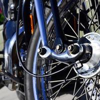 Fragment of chromed shiny wheel of old classic motorbike photo