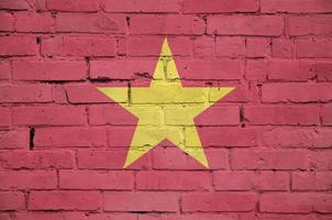 Vietnam flag is painted onto an old brick wall photo