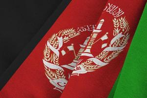 Afghanistan flag with big folds waving close up under the studio light indoors. The official symbols and colors in banner photo