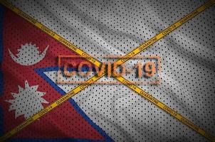 Nepal flag and Covid-19 stamp with orange quarantine border tape cross. Coronavirus or 2019-nCov virus concept photo