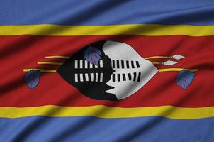 Swaziland flag  is depicted on a sports cloth fabric with many folds. Sport team banner photo