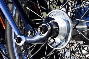 Fragment of chromed shiny wheel of old classic motorbike photo