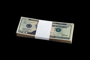 Bundle of US dollar bills isolated on black. Pack of american money with high resolution on perfect black background photo