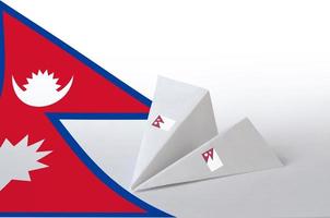 Nepal flag depicted on paper origami airplane. Handmade arts concept photo