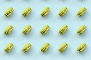 Green dessert cake macaron or macaroon on trendy pastel blue background top view. Flat lay pattern composition photo