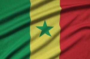 Senegal flag  is depicted on a sports cloth fabric with many folds. Sport team banner photo