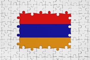 Armenia flag in frame of white puzzle pieces with missing central part photo