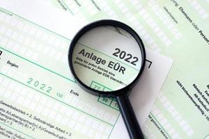 Anlage EUR - German 2022 Profit and Loss Statement and magnifying glass close up. The concept of taxation and accountant paperwork Germany photo