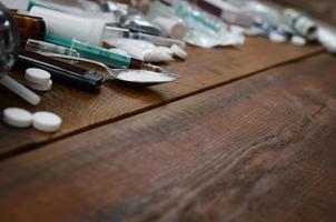 A lot of narcotic substances and devices for the preparation of drugs lie on an old wooden table photo