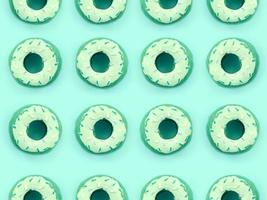 Many small plastic donuts lies on a pastel colorful background. Flat lay minimal pattern. Top view photo