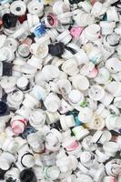 A pattern of many used and soiled nozzles from spray cans with aerosol paint. Background texture of the street art of drawing graffiti on the walls photo