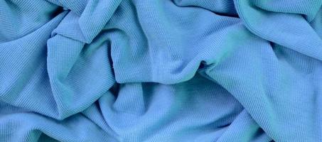 The texture of the fabric in blue color. Material for making shirts and blouses photo