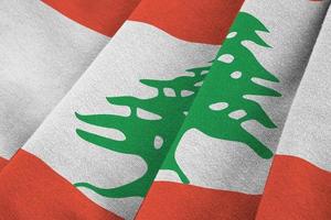 Lebanon flag with big folds waving close up under the studio light indoors. The official symbols and colors in banner photo