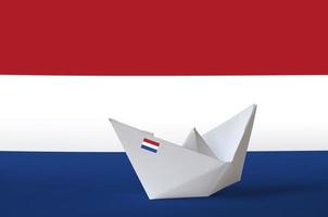 Netherlands flag depicted on paper origami ship closeup. Handmade arts concept photo