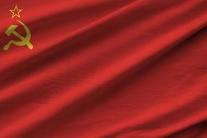 Soviet Union flag with big folds waving close up under the studio light indoors. The official symbols and colors in banner photo