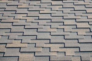 Modern roofing and decoration of chimneys. Flexible bitumen or slate shingles photo