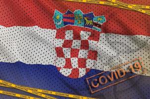 Croatia flag and Covid-19 biohazard symbol with quarantine orange tape and stamp. Coronavirus or 2019-nCov virus concept photo