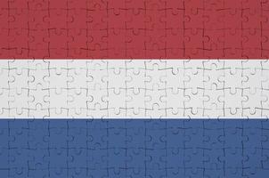 Netherlands flag  is depicted on a folded puzzle photo