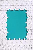 Framing in the form of a rectangle, made of a white jigsaw puzzle around the blue space photo