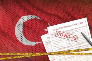 Turkey flag and Health insurance claim form with covid-19 stamp. Coronavirus or 2019-nCov virus concept photo