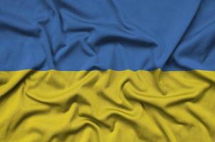 Ukraine flag  is depicted on a sports cloth fabric with many folds. Sport team banner photo