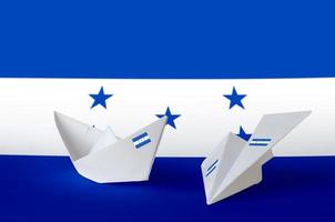 Honduras flag depicted on paper origami airplane and boat. Handmade arts concept photo