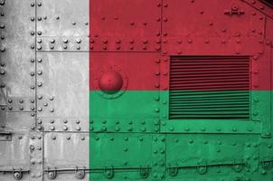 Madagascar flag depicted on side part of military armored tank closeup. Army forces conceptual background photo