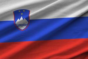 Slovenia flag with big folds waving close up under the studio light indoors. The official symbols and colors in banner photo