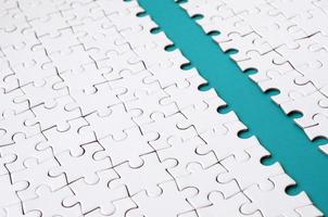 The blue path is laid on the platform of a white folded jigsaw puzzle. Texture image with copy space for text photo