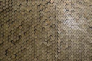 Pattern of 12 gauge cartridges for shotgun bullets. Shells for hunting rifle close up. Backdrop for shooting range or ammunition trade concepts photo