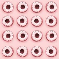 muchos pequeños donuts de plástico se encuentran sobre un fondo de colores pastel. patrón mínimo plano. vista superior foto