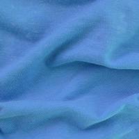 The texture of the fabric in blue color. Material for making shirts and blouses photo