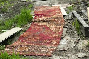 alfombra roja en la carretera en el campo. camino en el pueblo. alfombra. foto