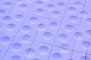 The close-up of violet detailed sphere texture reverse side of the plastic tile. Rough embossed lattice. Concept of design. Wall decoration interior. Relief balls geometric pattern. Flatlay, mock up photo