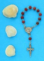 Pilgrim scallop shells and wooden rosary beads with crucifix cross with copy space on blue background. St. James Way symbol, camino Santiago de Compostela emblem route signs flatlay, topview concept photo