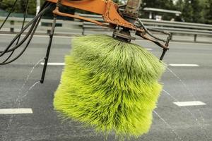 Washing car on road. Brush for washing asphalt. Special equipment in city. photo