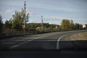 Sharp turn of road. Bending of road with markings. Red turn signs. photo