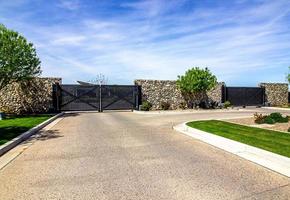 Entrance And Exit Gates To Secure Housing Development photo