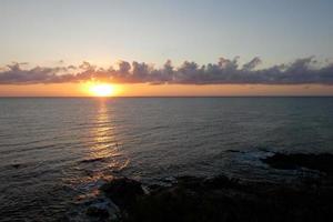 Sun disk rising over the horizon of the sea, sunrise, dawn photo