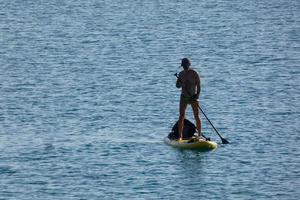 swimmer on vacation paddle surfing in the mediterranean sea photo