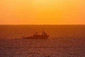 Fishermen returning from fishing at dawn after spending the whole night at sea. photo