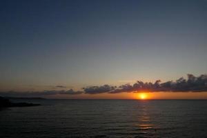 Sun disk rising over the horizon of the sea, sunrise, dawn photo